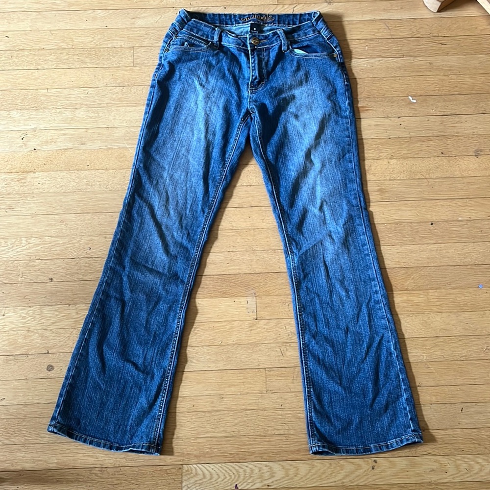 Womens low rise boot cut jeans with jewels and designs sewed on the back pockets
